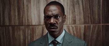 Movie still from “Imagine That” (2009), directed by Karey Kirkpatrick – A person wearing a suit and tie; Close Up shot, Low angle