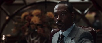 Movie still from “Imagine That” (2009), directed by Karey Kirkpatrick – A person wearing a suit and tie; Close Up shot, Low angle