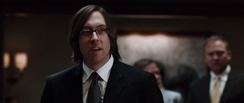 Movie still from “Imagine That” (2009), directed by Karey Kirkpatrick – A person wearing a suit and tie; Close Up shot, Over the shoulder angle