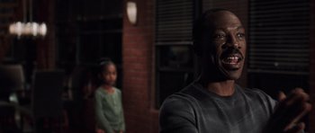 Movie still from “Imagine That” (2009), directed by Karey Kirkpatrick – A man and a little girl standing next to each other; Close Up shot, Over the shoulder angle