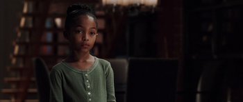 Movie still from “Imagine That” (2009), directed by Karey Kirkpatrick – A little girl in a green shirt is looking at the camera; Medium shot, Over the shoulder angle