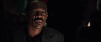 Movie still from “Imagine That” (2009), directed by Karey Kirkpatrick – A person wearing a suit and tie; Close Up shot, Low angle