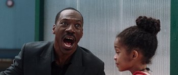 Movie still from “Imagine That” (2009), directed by Karey Kirkpatrick – A man and a little girl looking surprised; Close Up shot, Over the shoulder angle