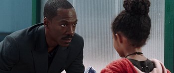 Movie still from “Imagine That” (2009), directed by Karey Kirkpatrick – A man sitting in front of two children; Close Up shot, Over the shoulder angle