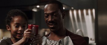 Movie still from “Imagine That” (2009), directed by Karey Kirkpatrick – A person holding a phone; Close Up shot, High angle