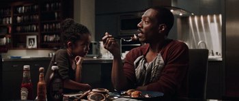 Movie still from “Imagine That” (2009), directed by Karey Kirkpatrick – A man sitting at a table with a little girl; Medium shot, Over the shoulder angle