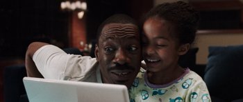 Movie still from “Imagine That” (2009), directed by Karey Kirkpatrick – A man and a little girl are looking at a laptop; Close Up shot, High angle