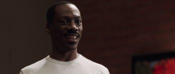 Movie still from “Imagine That” (2009), directed by Karey Kirkpatrick – A person wearing a white t - shirt; Close Up shot, Low angle