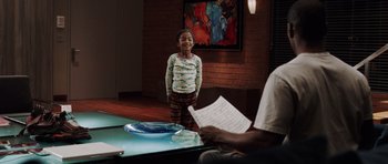 Movie still from “Imagine That” (2009), directed by Karey Kirkpatrick – A young girl standing in front of an older man holding a paper; Medium shot, Over the shoulder angle