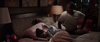 Movie still from “Imagine That” (2009), directed by Karey Kirkpatrick – A man and a little girl laying in a bed next to each other; Medium shot, Over the shoulder angle