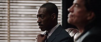 Movie still from “Imagine That” (2009), directed by Karey Kirkpatrick – A man that is tying his tie; Close Up shot, Over the shoulder angle