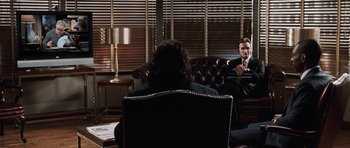 Movie still from “Imagine That” (2009), directed by Karey Kirkpatrick – Two people sitting on a couch in front of a window; Wide shot, Over the shoulder angle