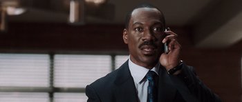 Movie still from “Imagine That” (2009), directed by Karey Kirkpatrick – A man talking on a cell phone; Close Up shot, High angle