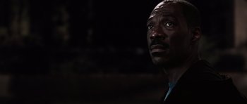 Movie still from “Imagine That” (2009), directed by Karey Kirkpatrick – A black man looking up at the sky; Close Up shot, Low angle