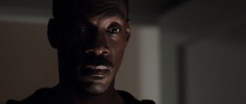Movie still from “Imagine That” (2009), directed by Karey Kirkpatrick – A man's face in the dark; Close Up shot, Low angle