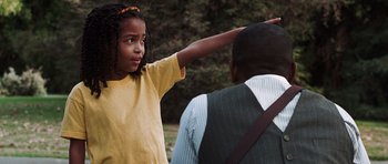 Movie still from “Imagine That” (2009), directed by Karey Kirkpatrick – A little girl standing next to an older man; Medium shot, Over the shoulder angle