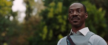 Movie still from “Imagine That” (2009), directed by Karey Kirkpatrick – A person wearing a suit and tie; Close Up shot, Low angle