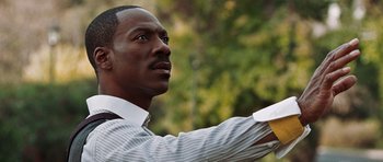 Movie still from “Imagine That” (2009), directed by Karey Kirkpatrick – A man in a white dress shirt is holding a white object; Close Up shot, Low angle