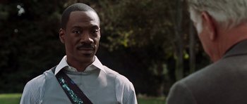 Movie still from “Imagine That” (2009), directed by Karey Kirkpatrick – A person wearing a shirt and tie; Close Up shot, Over the shoulder angle