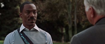 Movie still from “Imagine That” (2009), directed by Karey Kirkpatrick – A person wearing a shirt and tie; Close Up shot, Over the shoulder angle