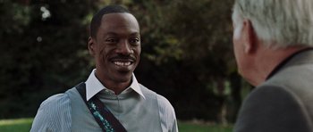 Movie still from “Imagine That” (2009), directed by Karey Kirkpatrick – A person wearing a shirt and tie; Close Up shot, Over the shoulder angle