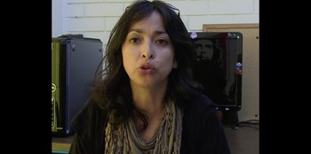 Movie still from “In Broad Daylight: The Narvarte Case” (2022), directed by Alberto Saúl Arnaut Estrada – A woman with long black curly hair is making a funny face; Close Up shot, High angle