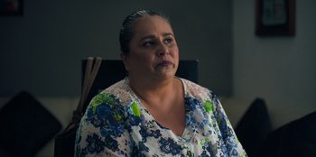 Movie still from “In Broad Daylight: The Narvarte Case” (2022), directed by Alberto Saúl Arnaut Estrada – A person sitting in a chair; Close Up shot, Over the shoulder angle