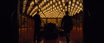Movie still from “Inception” (2010), directed by Christopher Nolan – Two men standing in front of an illuminated ceiling; Extreme Wide shot, Low angle