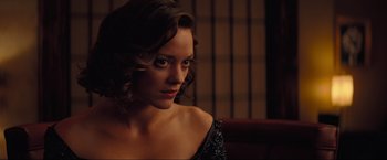 Movie still from “Inception” (2010), directed by Christopher Nolan – A beautiful woman with short hair wearing a black dress; Close Up shot, Over the shoulder angle