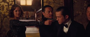 Movie still from “Inception” (2010), directed by Christopher Nolan – A man holding a gun pointed at another man's face; Medium shot, Over the shoulder angle