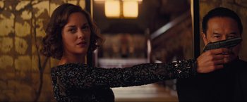 Movie still from “Inception” (2010), directed by Christopher Nolan – A woman in a black dress is holding her arm out; Close Up shot, Over the shoulder angle