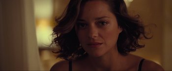 Movie still from “Inception” (2010), directed by Christopher Nolan – A woman's face in a dark room; Close Up shot, Over the shoulder angle