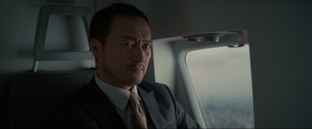 Movie still from “Inception” (2010), directed by Christopher Nolan – A person wearing a suit and tie; Close Up shot, Low angle