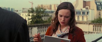 Movie still from “Inception” (2010), directed by Christopher Nolan – A woman is looking at a tablet computer while holding a pen; Close Up shot, High angle