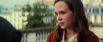 Movie still from “Inception” (2010), directed by Christopher Nolan – A woman with long brown hair wearing a brown jacket; Close Up shot, Over the shoulder angle