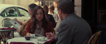 Movie still from “Inception” (2010), directed by Christopher Nolan – A woman sitting at a table in front of a man; Medium shot, Over the shoulder angle