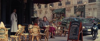 Movie still from “Inception” (2010), directed by Christopher Nolan – A man and a woman are sitting at a table outside; Wide shot, Over the shoulder angle