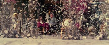 Movie still from “Inception” (2010), directed by Christopher Nolan – A man and a woman sitting on a chair in front of a tree; Wide shot, Over the shoulder angle