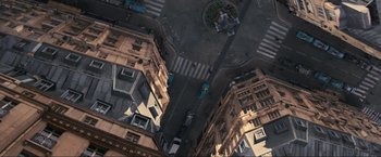 Movie still from “Inception” (2010), directed by Christopher Nolan – An aerial view of a city street with cars driving down it; Extreme Wide shot, Overhead angle