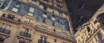 Movie still from “Inception” (2010), directed by Christopher Nolan – A building that has many balconies on it; Extreme Wide shot, Low angle