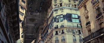 Movie still from “Inception” (2010), directed by Christopher Nolan – A very tall building that has many balconies on it; Extreme Wide shot, Overhead angle