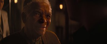 Movie still from “Inception” (2010), directed by Christopher Nolan – An older woman smiling for the camera; Close Up shot, High angle