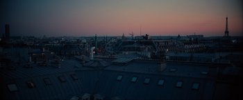 Movie still from “Inception” (2010), directed by Christopher Nolan – A view of a city at night from a roof top; Extreme Wide shot, High angle