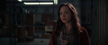 Movie still from “Inception” (2010), directed by Christopher Nolan – A woman with long brown hair wearing a red jacket; Close Up shot, Over the shoulder angle