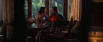 Movie still from “Inception” (2010), directed by Christopher Nolan – A man and a woman sitting at a table talking to each other; Wide shot, Over the shoulder angle