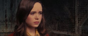 Movie still from “Inception” (2010), directed by Christopher Nolan – A woman with long brown hair wearing a yellow scarf; Close Up shot, Over the shoulder angle