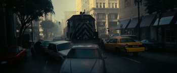 Movie still from “Inception” (2010), directed by Christopher Nolan – A truck driving down a street next to a street light; Extreme Wide shot, Low angle