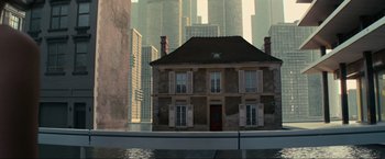 Movie still from “Inception” (2010), directed by Christopher Nolan – An image of a house in the middle of a city; Extreme Wide shot, High angle