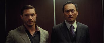 Movie still from “Inception” (2010), directed by Christopher Nolan – A couple of men standing next to each other in a room; Close Up shot, Low angle