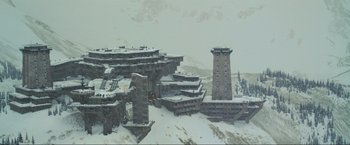 Movie still from “Inception” (2010), directed by Christopher Nolan – An image of an abandoned building in the middle of the snow; Extreme Wide shot, High angle